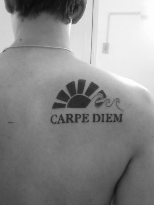 Carpe Diem lettering in simple font style tattooed on foot
