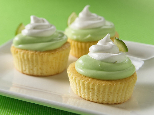 celebratewithcake:

sweettoothgirl:

Mini Key Lime Cupcakes
Ingredients:
Topping:

1 box (4-serving size) vanilla instant pudding and pie filling mix
1 1/2 cups whipping cream
1/4 cup Key lime or regular lime juice
4 drops green food color
1 1/2 cups powdered sugar

Cupcakes:

48 regular-size paper baking cups
1 box Betty Crocker Super Moist yellow cake mix
Water, vegetable oil and eggs called for on cake mix box

Frosting:

1 container Betty Crocker Whipped fluffy white frosting
1 tablespoon Key lime or regular lime juice
1/2 teaspoon grated Key lime or regular lime peel

Directions:

In a large bowl, beat pudding mix and whipping cream with wire whisk 2 minutes. Let stand 3 minutes. Beat in 1/4 cup Key lime juice and the food color; stir in powdered sugar until smooth. Cover and refrigerate.
Heat oven to 375 degreesF. (350 degreesF for dark or nonstick pans). Place paper baking cups in each of 24 regular-size muffin cups. Make cake batter as directed on box. Spoon about 1 rounded tablespoonful batter into each muffin cup, using about half of the batter. (Muffin cups will be about 1/3 full.) Refrigerate remaining batter. Bake 12 to 16 minutes or until toothpick inserted in center comes out clean. Remove from pan to cooling rack. Repeat with remaining baking cups and batter. Cool cupcakes completely, about 15 minutes.
Remove paper baking cups from cupcakes. Swirl about 2 teaspoons topping on top of each cupcake.
Stir frosting in containter 20 times. Gently stir in 1 tablespoon Key lime juice and the lime peel. Spoon frosting into 1-quart resealable food-storage plastic bag. Cut 1/2-inch opening from bottom corner of bag. Squeeze 1 rounded teaspoonful frosting from bag onto topping. Garnish with fresh lime wedge, if desired. Store in refrigerator.

High Altitude (3500-6500 ft): Divide batter in half. Distribute 1/2 batter evenly among 24 muffin cups. Refrigerate remaining batter, and repeat process.

Website | Recommend | Submit | Ask | Apparel