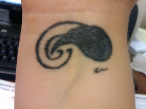 “my first tattoo (the snail looking thing) was on a whim. my best friend in 