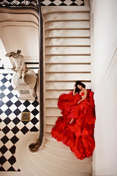 photographer Russell James Adriana Lima red dress spilling over stairs 