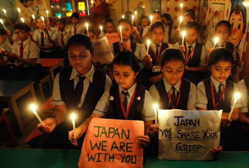 aoishinju:  Students hold candles as they pray for Japan’s earthquake victims inside their school in the western Indian city of Ahmedabad March 11. 