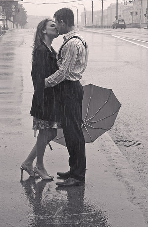 romantic couple kissing in rain. romantic couple kissing in the
