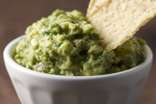 healthyblonde:

Low Fat Guacamole
24 Calories for 1/4 cup 3.6 carbohydrates 2g protein
Directions
Ingredients:* 10-ounce pack of frozen peas* 1/2 small ripe avocado* 1/2 cup cilantro, stems removed* 1/2 ripe tomato, de-seeded and chopped* 1/3 cup chopped onion (optional)* Squeeze of fresh lime juicePreparation:Cook peas according to package instructions. Empty into a colander, drain and rinse with cold water. Place peas, avocado and cilantro in a blender and blend to desired consistency. Spoon into a bowl with chopped tomato and onion. Add a squeeze of lime juice, stir and serve.
