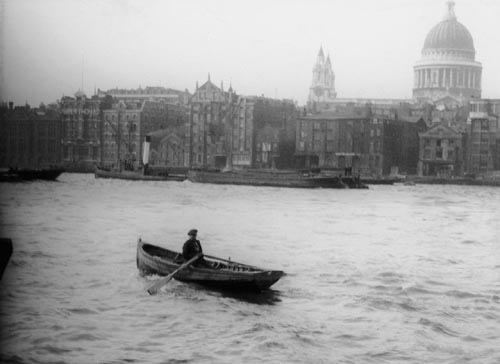 Man in a rowing boat on the River near St. Paul’s Cathedral. (by National Maritime Museum)