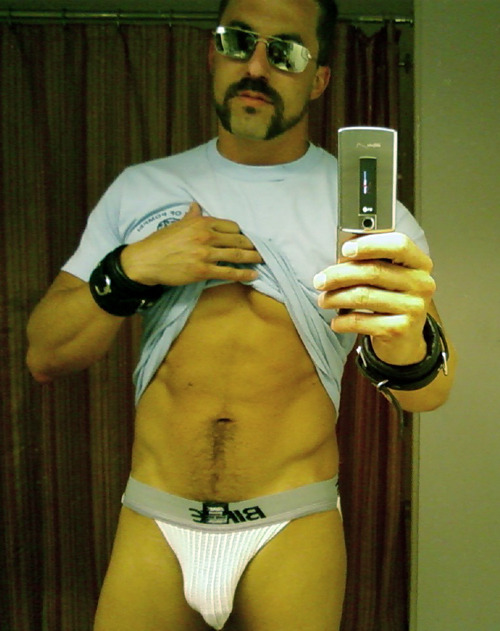 furrycubkc:

Looks like he is packing something FUN in his jock!  Are those leather wrist restraints?  Hmm…!?

