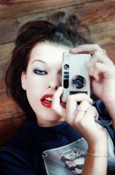 Milla Jovovich with point and shoot by Chris Floyd~UPDATE - Camera model is apparently a Contax T2 - I couldn&#8217;t identify it. Cheers to http://redfishingboat.tumblr.com for the heads up!